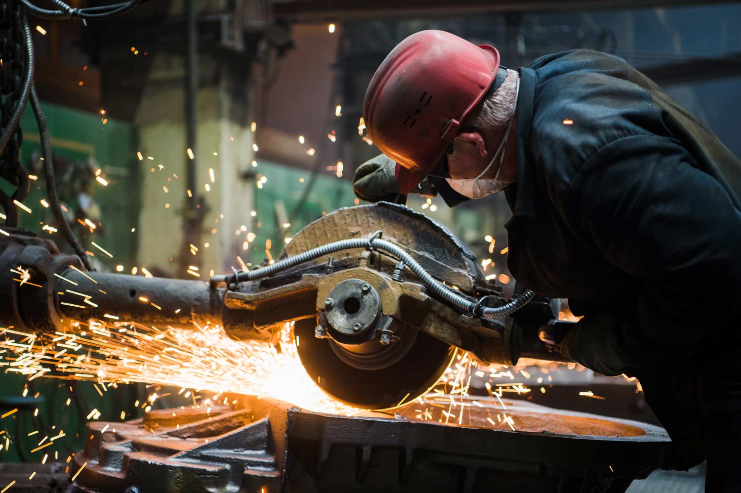 a worker grinding metal on site