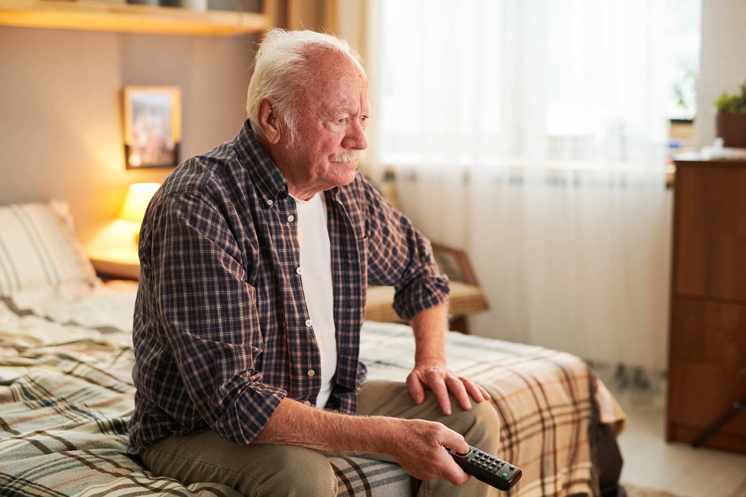 old-man-with-remote-control-choosing-channel-while